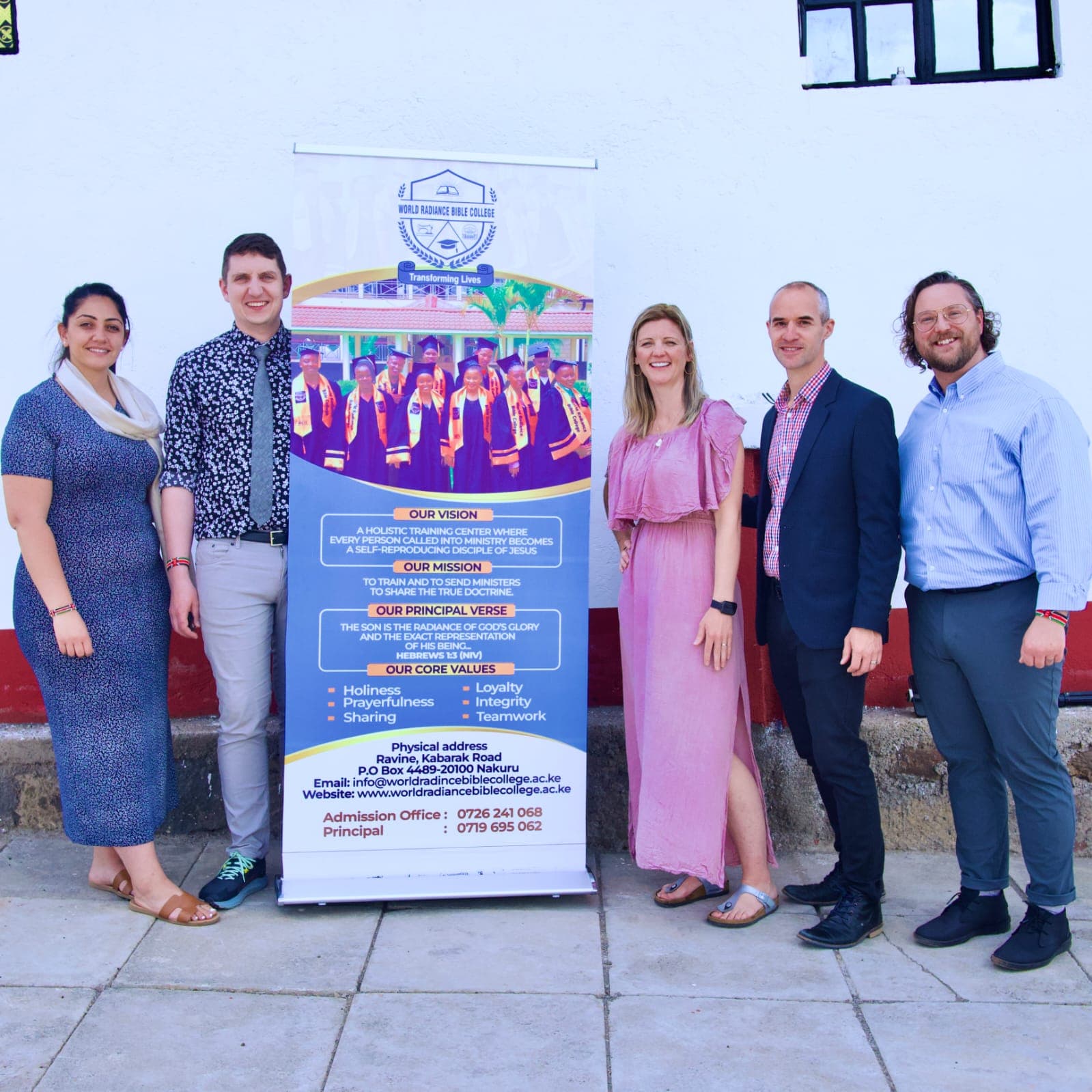 Visitors with the college banner on campus